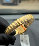 View of the bracelet on the Cartier Baignoire Small Model sapphire yellow gold women's watch.