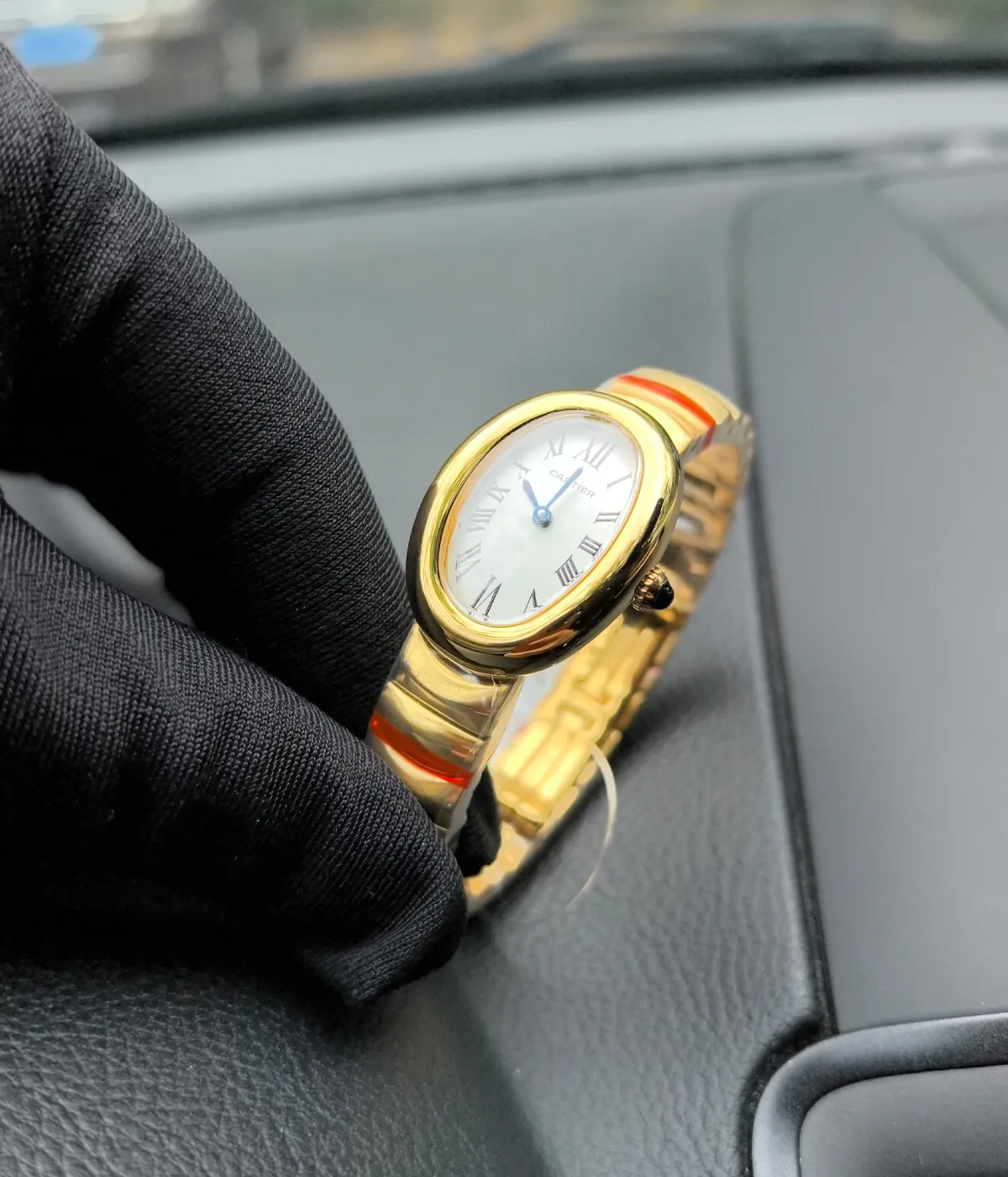 Close-up of the case of the Cartier Baignoire Small Model sapphire yellow gold women's watch.