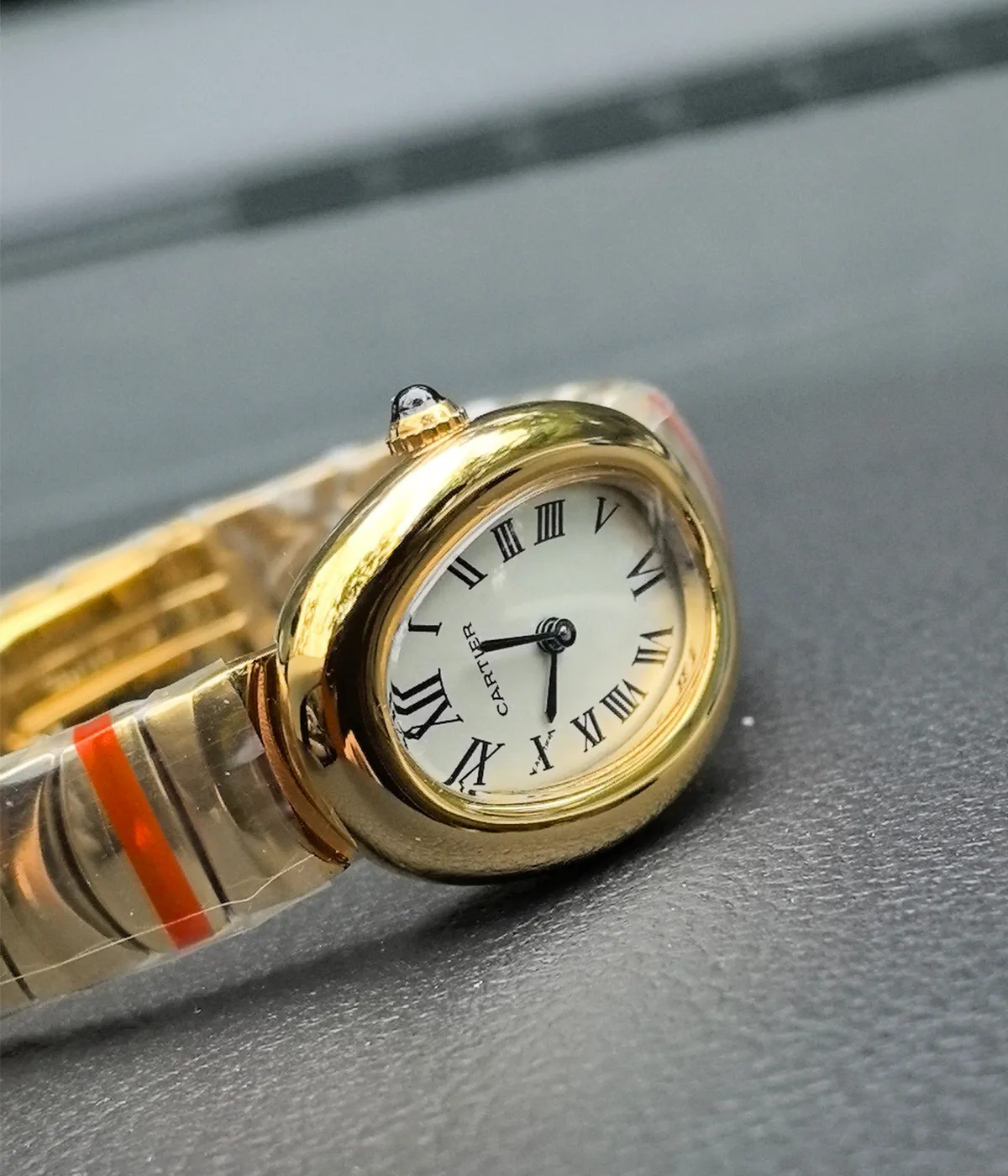 Close-up view of the dial on the Cartier Baignoire Small Model sapphire yellow gold women's watch.