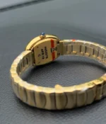 Close-up of the movement inside the Cartier Baignoire Small Model sapphire yellow gold women's watch.