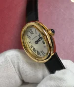 Close-up of the sapphire crown on the Cartier Baignoire WGBA0017 Small Model Sapphire Yellow Gold Women's Watch.