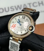 Close-up of the crown on the Cartier Ballon Bleu De Two Tone Rose Gold and Steel 36MM Diamond Set watch.