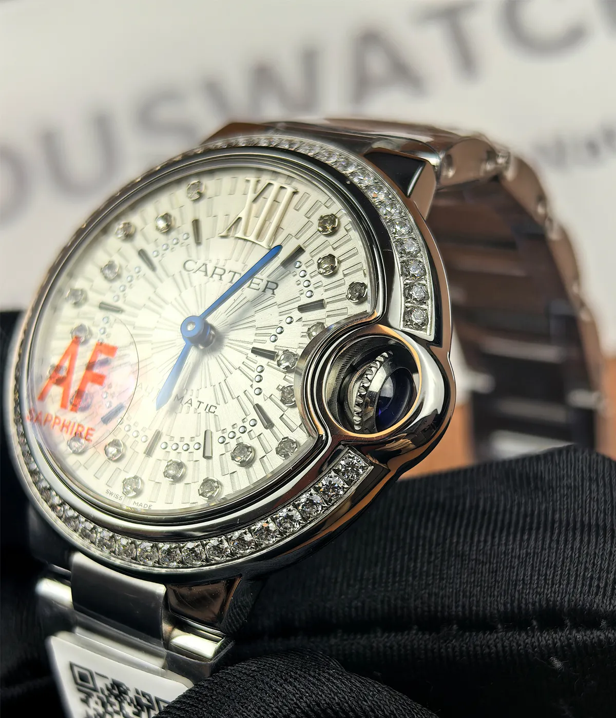 Close-up of the crown on the Cartier Ballon Bleu de White Dial with diamond accents women's watch.