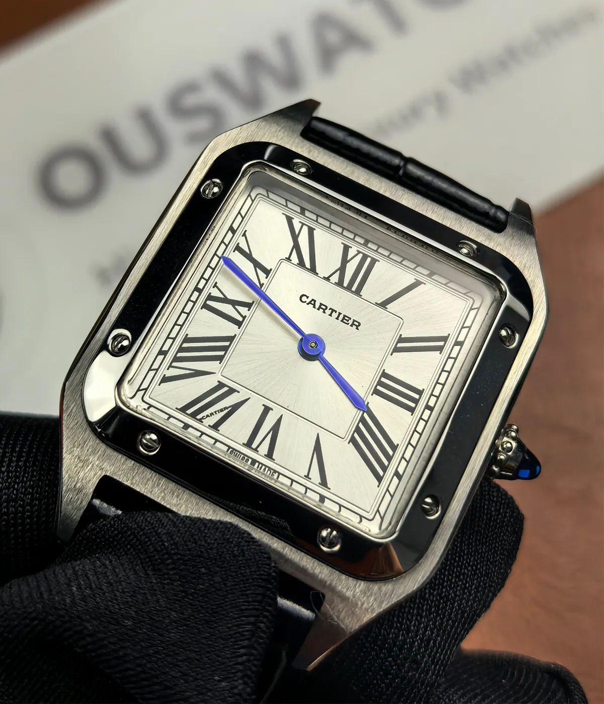 Close-up of the case and dial details on the Cartier WSSA0023 Santos Dumont Small Sapphire Crocodile Leather Watch Strap.