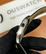 Close-up view of the crown on the Cartier WSSA0023 Santos Dumont Small watch.