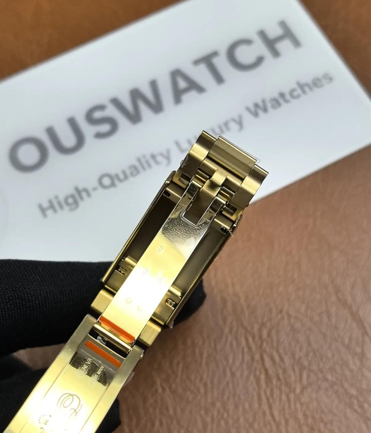 Display showing the clasp opened on the Golden Rolex Daytona 126518LN-0014 with an Oysterflex bracelet.