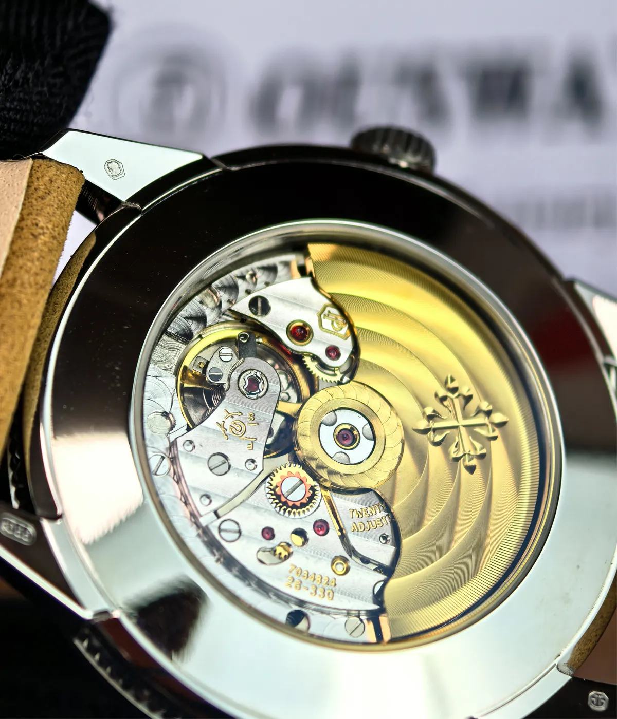 View of the transparent caseback of the Patek Philippe 5226G-001 Calatrava, showing the intricate movement inside.