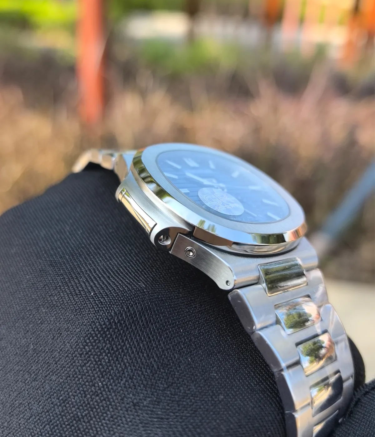 Side view of the Patek Philippe 5726/1A-014 Stainless Steel Blue Case 40mm, emphasizing the satin-finished case and smooth contours.