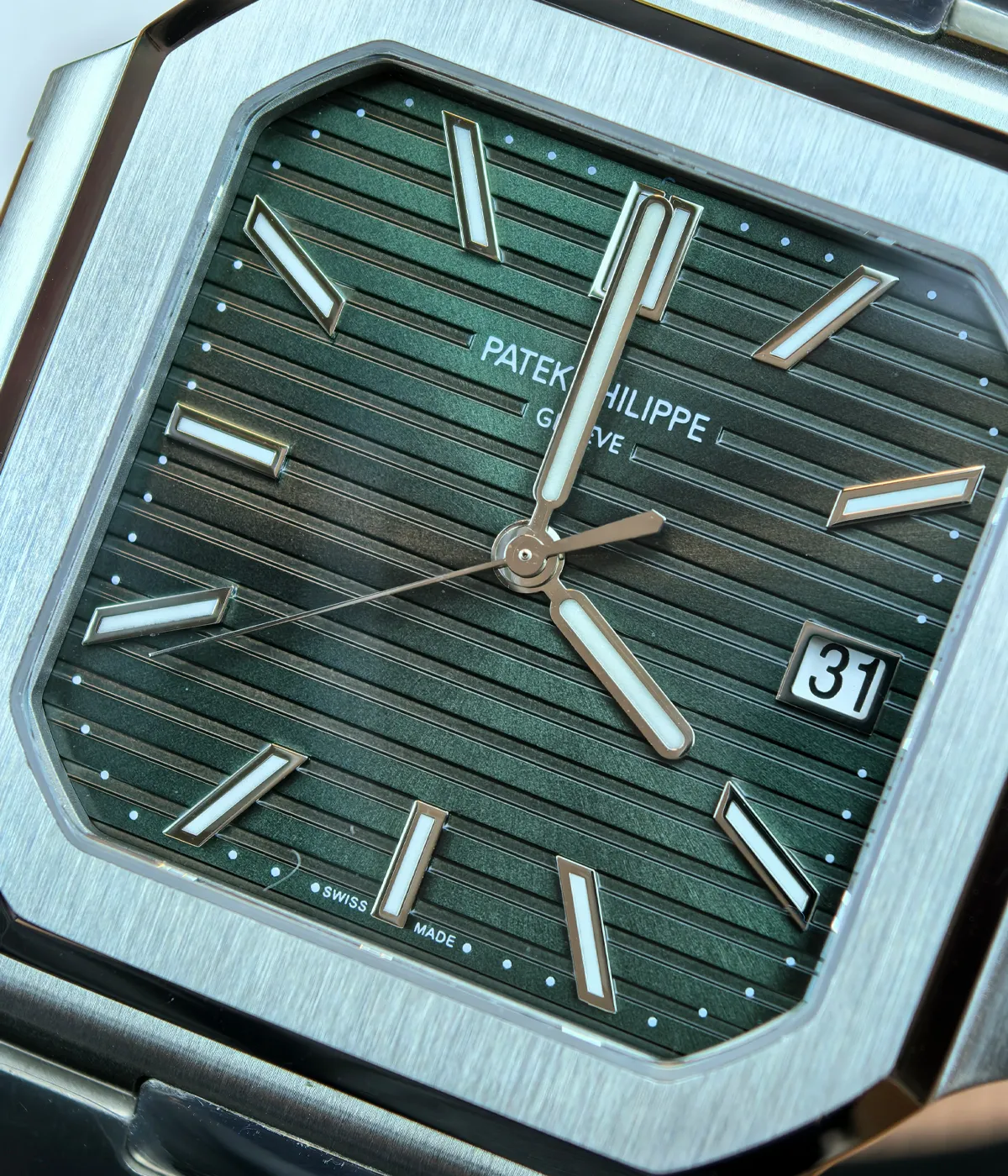 Close-up of the case and dial details of the Patek Philippe 5821/1A-001 men's watch with a green dial.