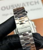 Close-up of the clasp on the Patek Philippe 5821/1A-001 men's watch with a green dial and steel strap.