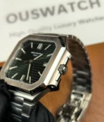 Close-up of the crown on the Patek Philippe 5821/1A-001 men's watch with a green dial and steel strap.