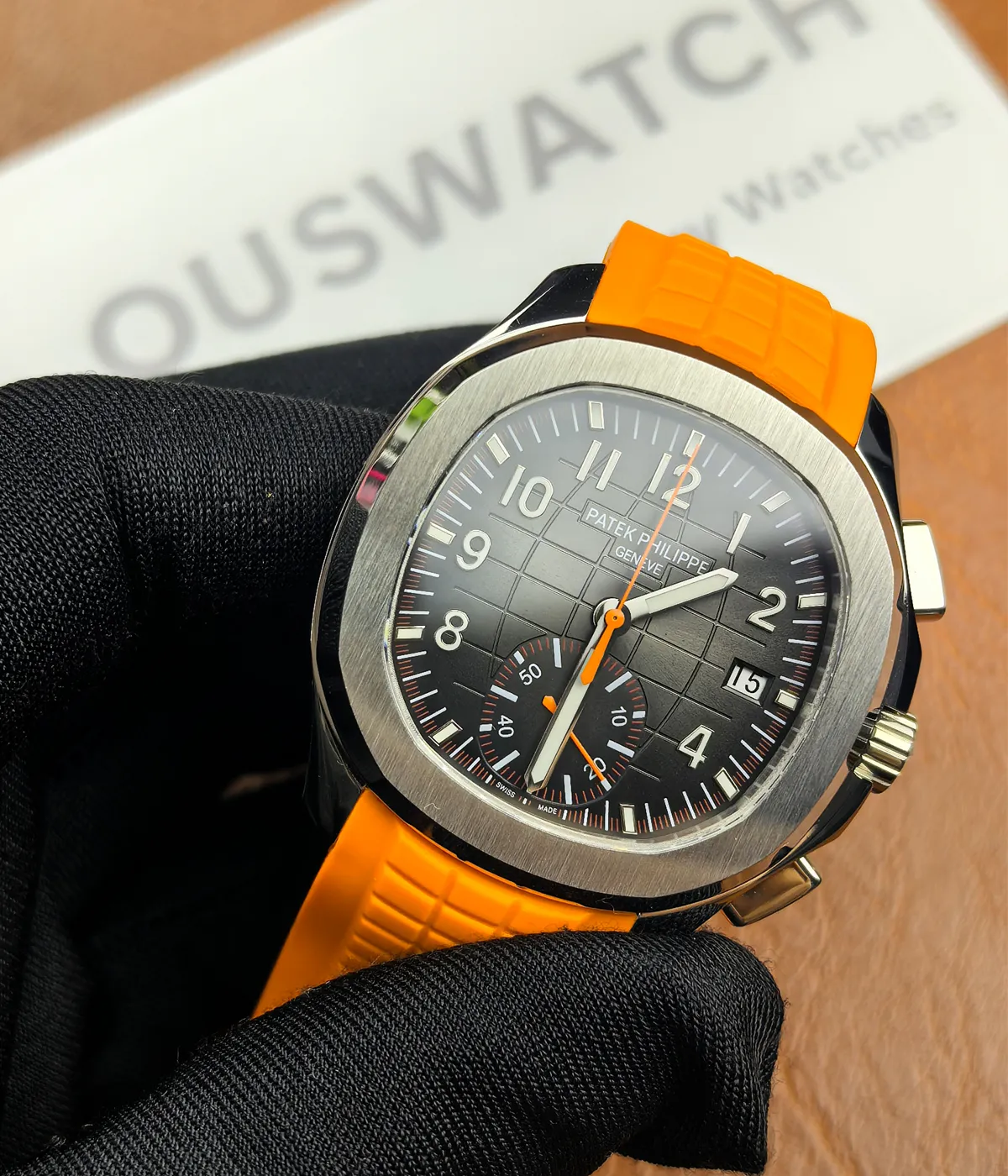 45-degree angle view of the Patek Philippe 5968A-001 Aquanaut with an orange strap and black dial.