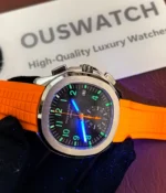 Luminous display of the Patek Philippe 5968A-001 Aquanaut with an orange strap and black dial in the dark.