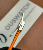 Close-up of the clasp on the Patek Philippe 5968A-001 Aquanaut with an orange strap.