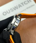 Close-up of the crown on the Patek Philippe 5968A-001 Aquanaut with an orange strap.