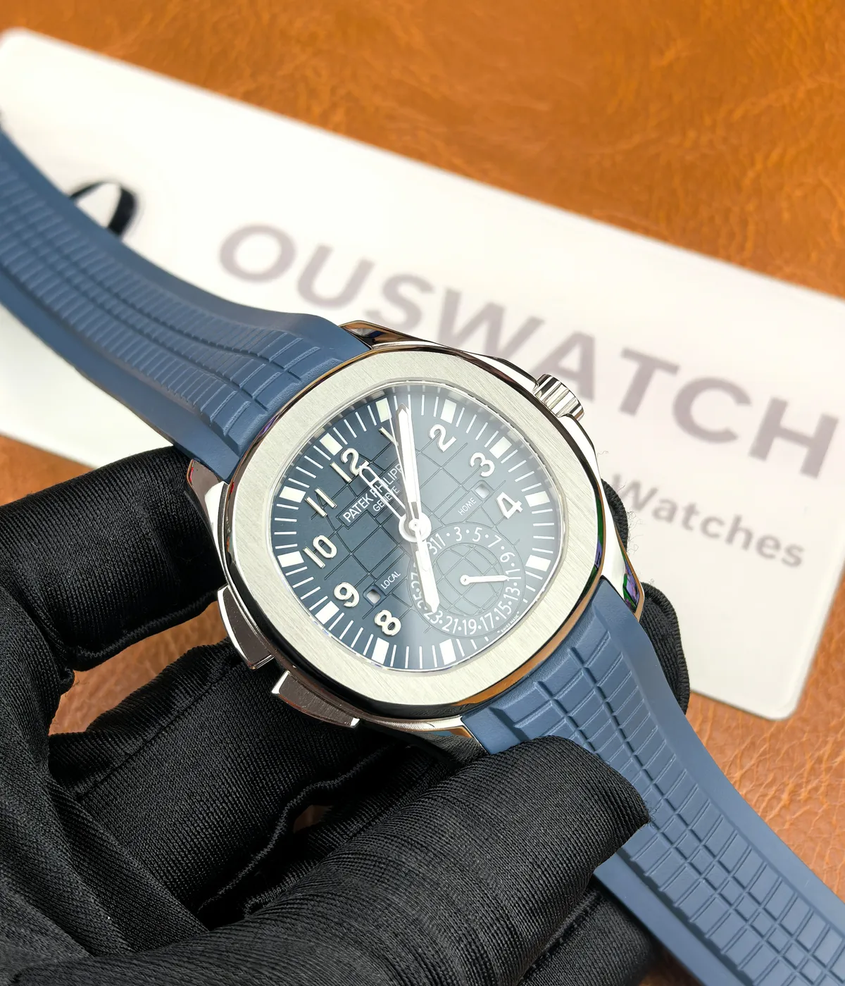 Close-up front view of the Patek Philippe Aquanaut Travel Time 5164G-001, showcasing the blue dial and white gold case.