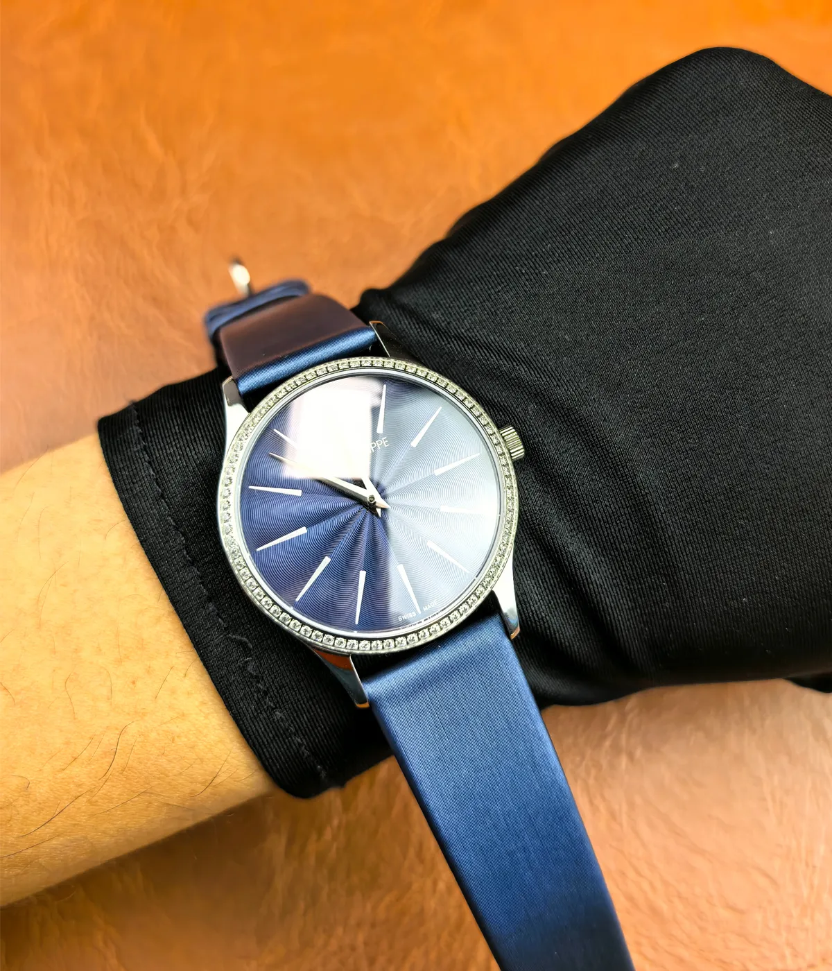 The Patek Philippe Calatrava 4897G-001 33mm watch on a woman's wrist, showing how it fits and looks when worn.