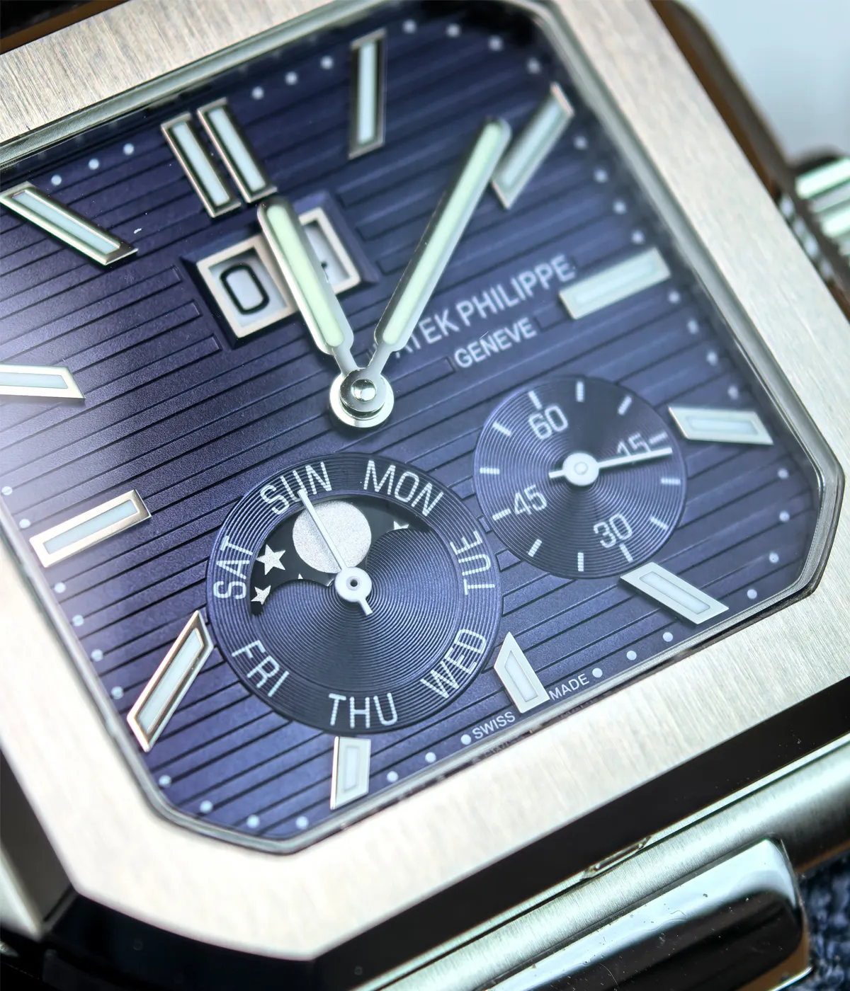 Close-up of the dial and case of the Patek Philippe Cubitus Watch 5822P-001 Blue Dial. Let me know if you need further adjustments!