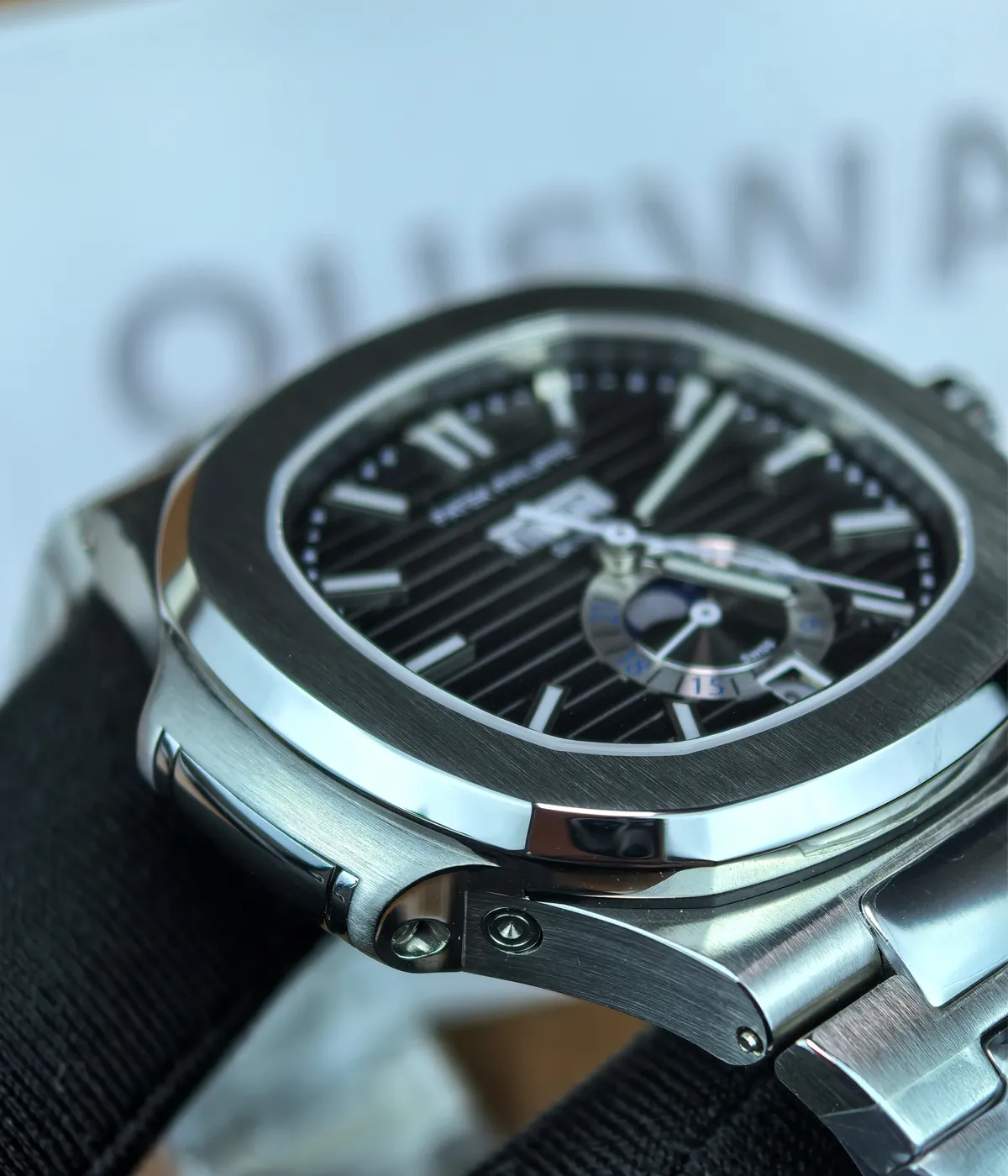 Side and lugs view of the Patek Philippe Nautilus 5726A-001 Moonphase Black Dial, showcasing the smooth transition from the case to the strap.