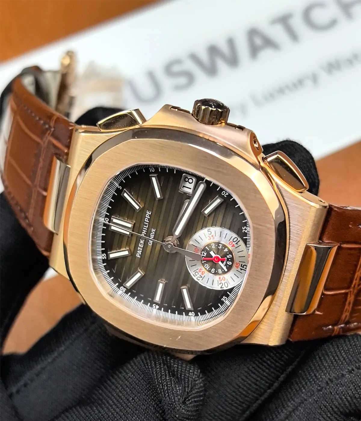 180-degree angle view of the Patek Philippe Nautilus 5980R-001 in rose gold with a brown dial.
