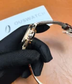 Close-up of the crown on the Patek Philippe Nautilus 5980R-001 in rose gold with a brown dial.