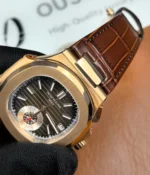 Close-up of the lugs on the Patek Philippe Nautilus 5980R-001 in rose gold with a brown dial.