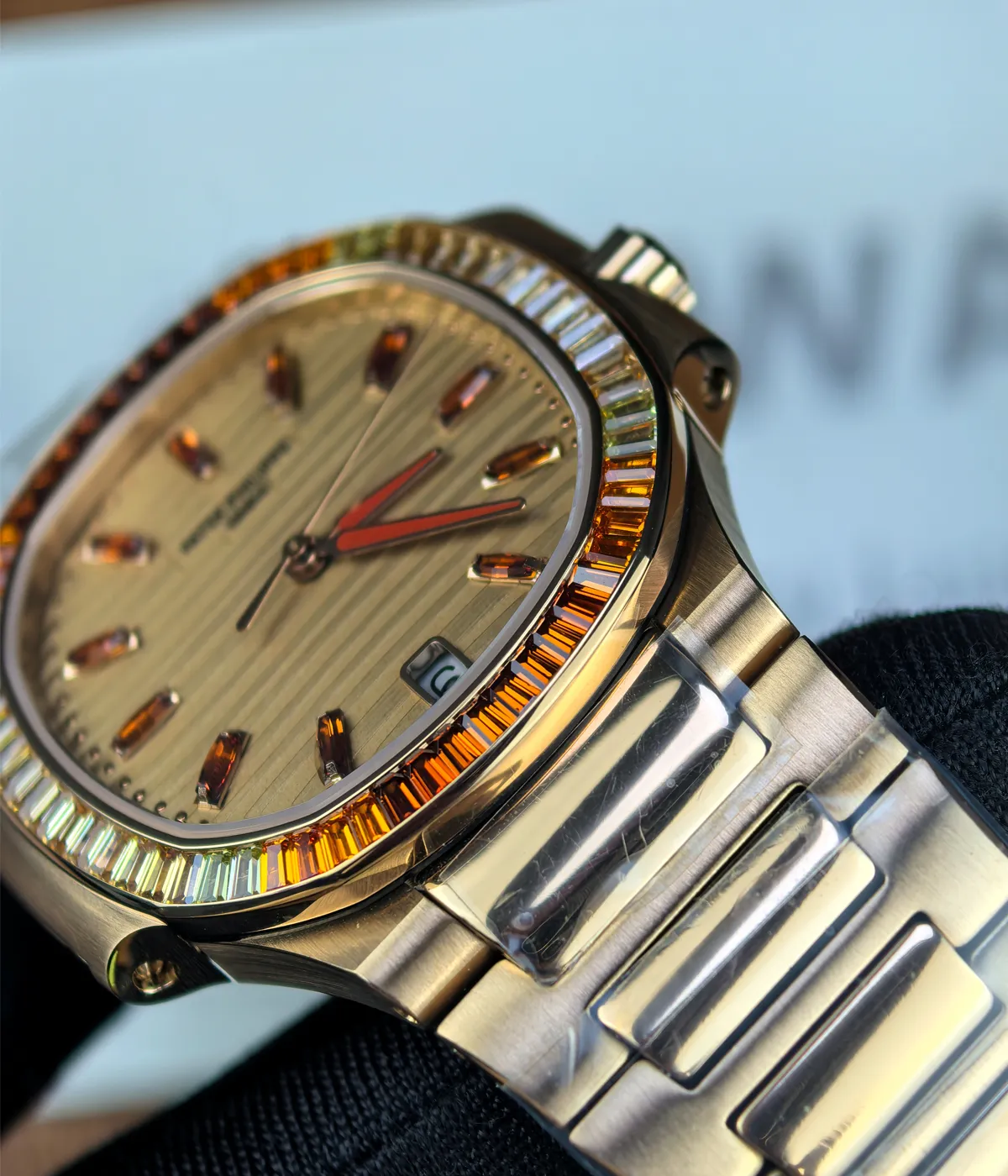 Close-up of the dial on the Patek Philippe Nautilus 7118-1300R-001, showing markers and ruby accents.