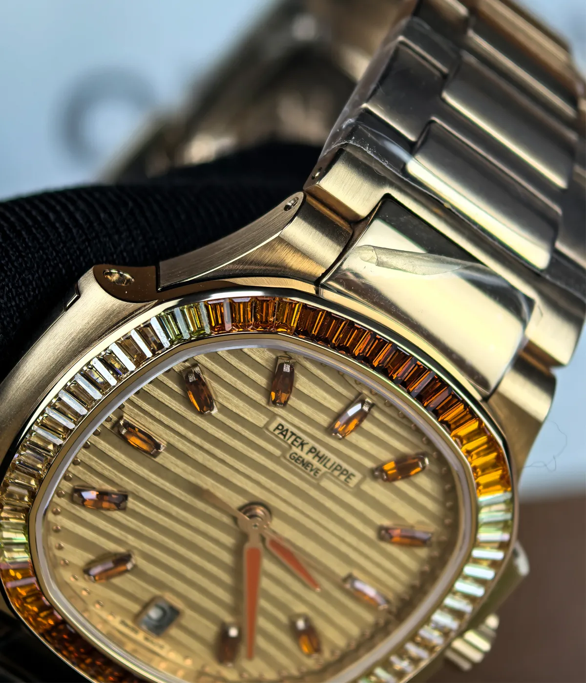 Macro shot highlighting the ruby gemstone details on the dial of the Patek Philippe Nautilus 7118-1300R-001.