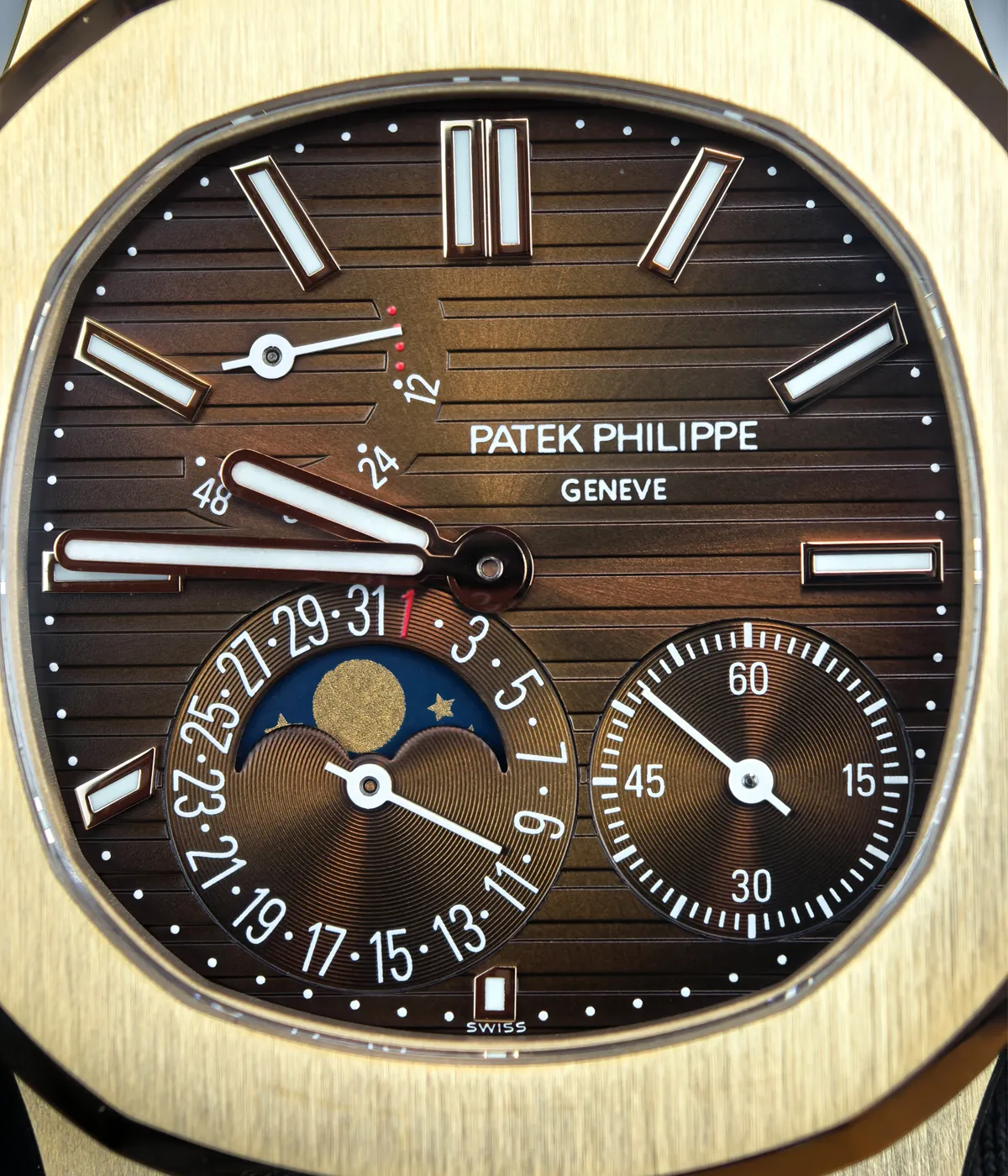 Detailed view of the dial of the Patek Philippe Nautilus Moonphase 5712-1R Rose Gold, highlighting the moonphase complication and intricate design elements.