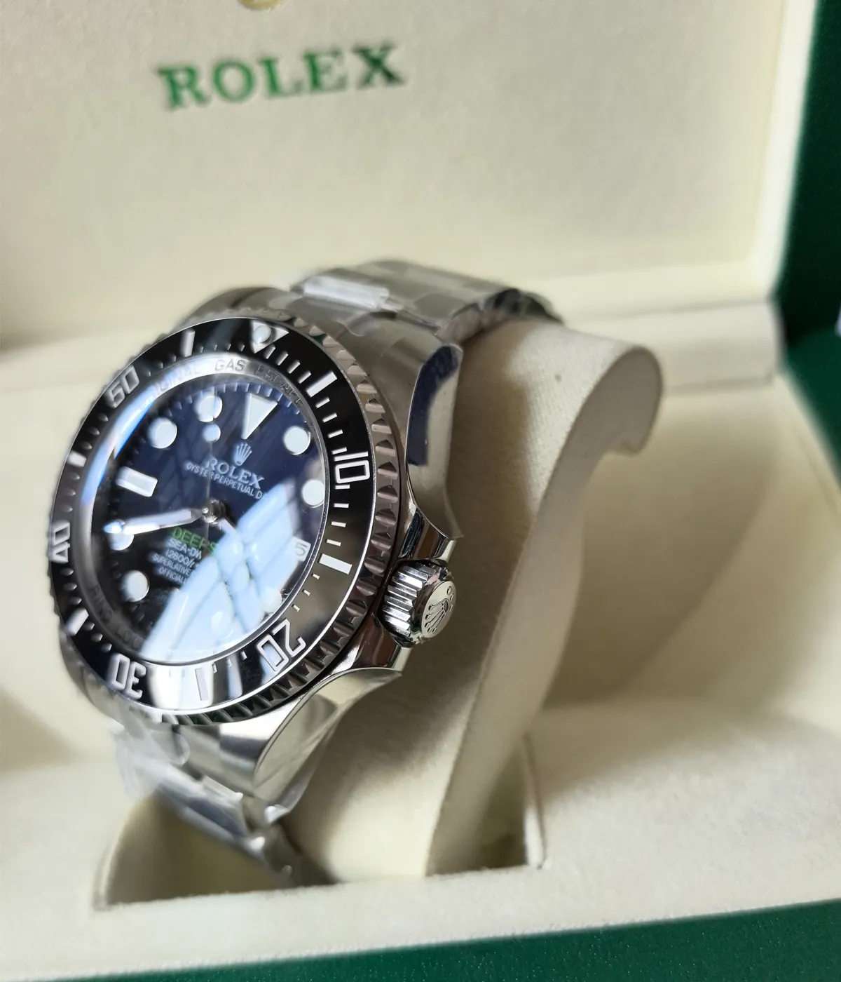 Side view showcasing the crown and black ceramic bezel on the Rolex 44MM D-Blue Dial M136660-0005 with an Oyster strap.