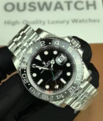 -45-degree angle view of the Rolex Bruce Wayne GMT Master II 126710GRNR 40mm with a ceramic bezel, black dial, and green hands.