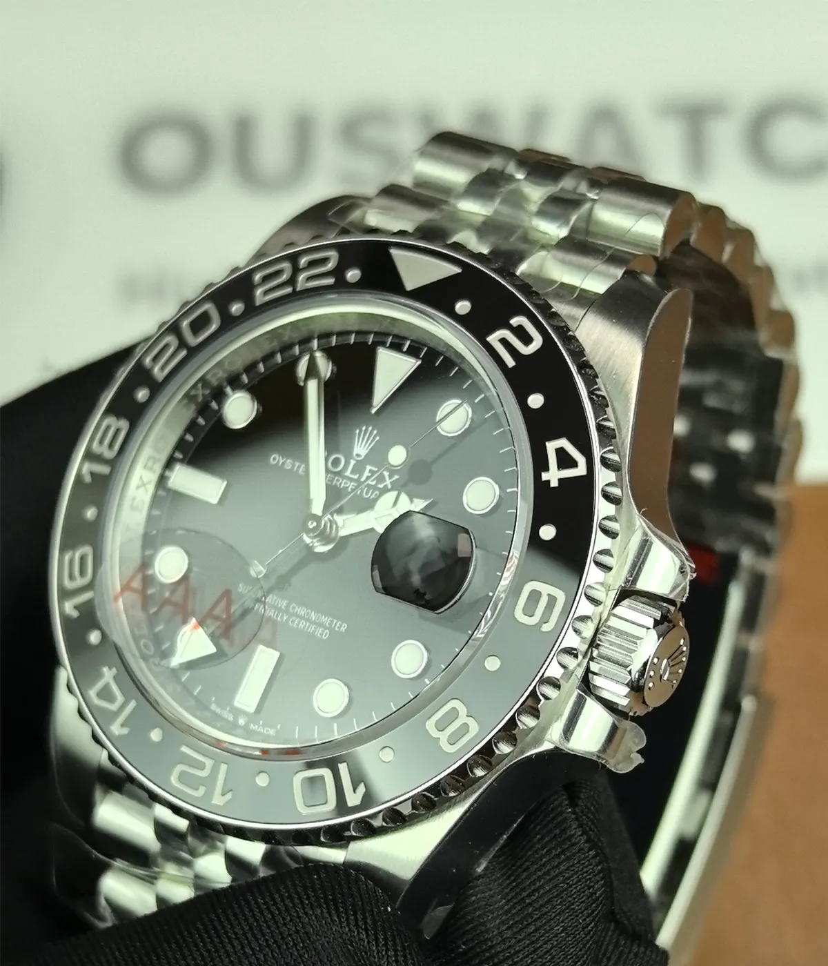 Close-up of the ceramic bezel on the Rolex Bruce Wayne GMT Master II 126710GRNR 40mm men's watch.