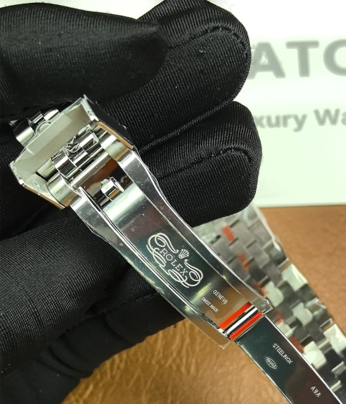 Detailed close-up of the clasp on the Rolex Bruce Wayne GMT Master II 126710GRNR 40mm men's watch.