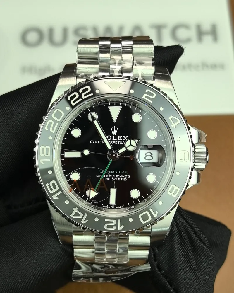 Front view of the Rolex Bruce Wayne GMT Master II 126710GRNR 40mm with a ceramic bezel, black dial, and green hands.