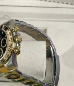 Close-up of the crown on the Rolex Cosmograph Daytona Yellow Rolesor M126503 men's watch.