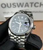 Close-up of the dial and bezel on the Rolex Datejust 36mm M126234-0015 with a black dial and two-tone case.