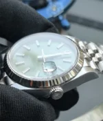 Close-up of the crown on the Rolex Datejust 36mm M126234-0051 with a mint olive green dial and two-tone case.