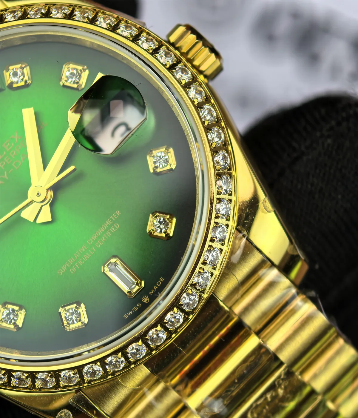 Close-up of the dial and diamond bezel on the Rolex Day-Date M128348RBR-0035 with a green dial and gold Oyster strap for women.