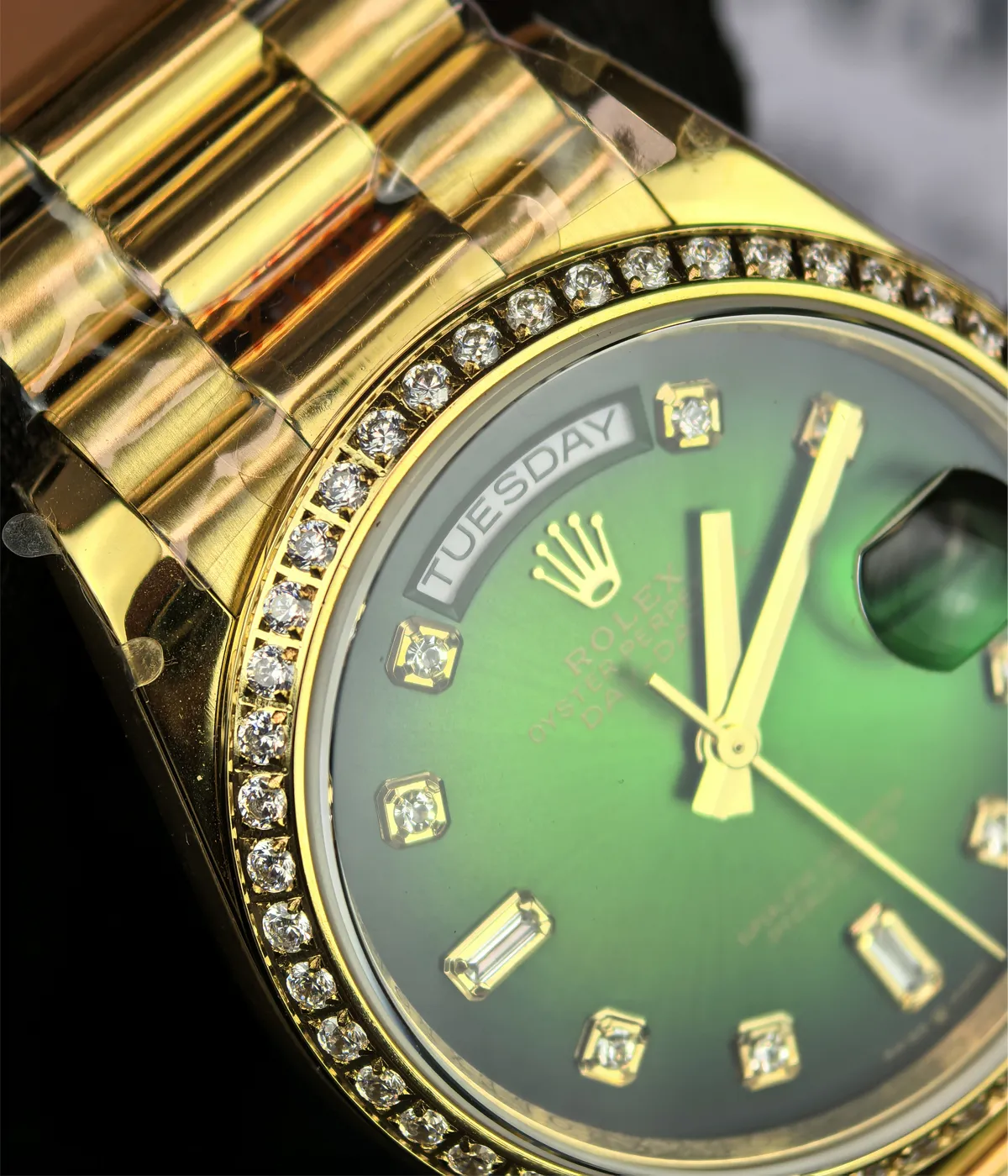 Close-up of the lugs and diamond bezel on the Rolex Day-Date M128348RBR-0035 with a green dial and gold Oyster strap.