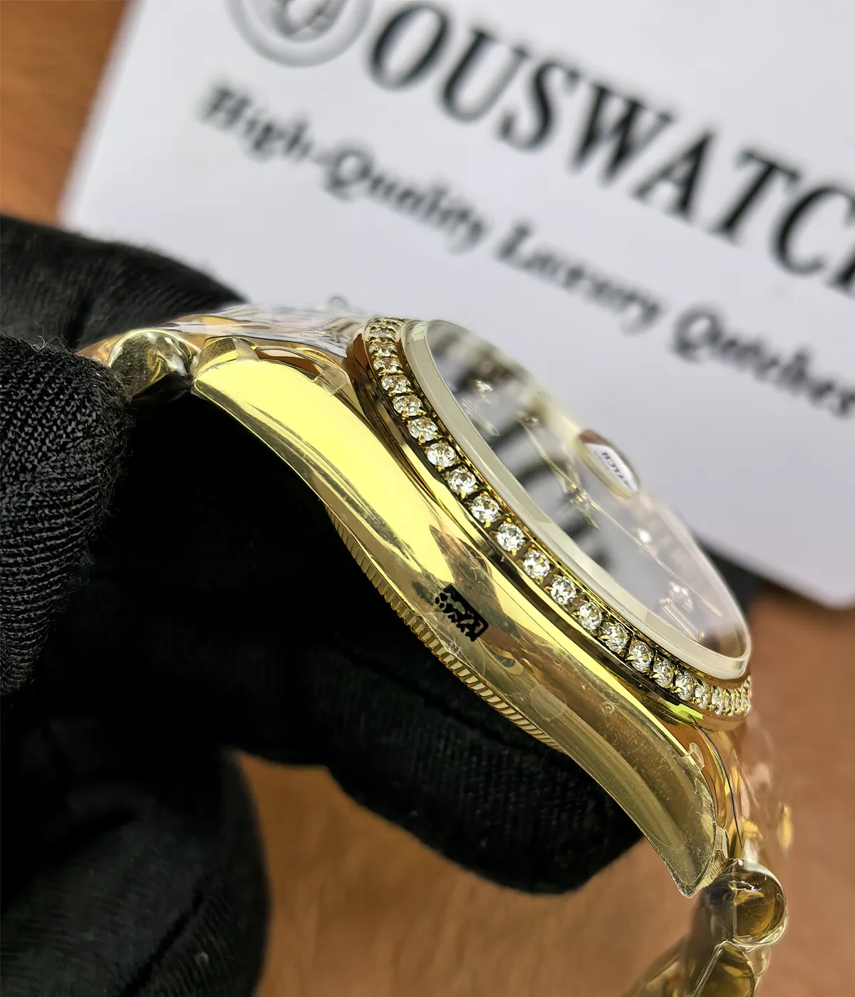 Side view showcasing the satin finish on the case of the Rolex Day-Date M128348RBR-0035 with a green dial, gold Oyster strap, and diamond bezel for women.