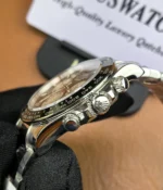 Close-up of the crown on the Rolex Daytona Le Mans 126529LN White Gold men's watch.