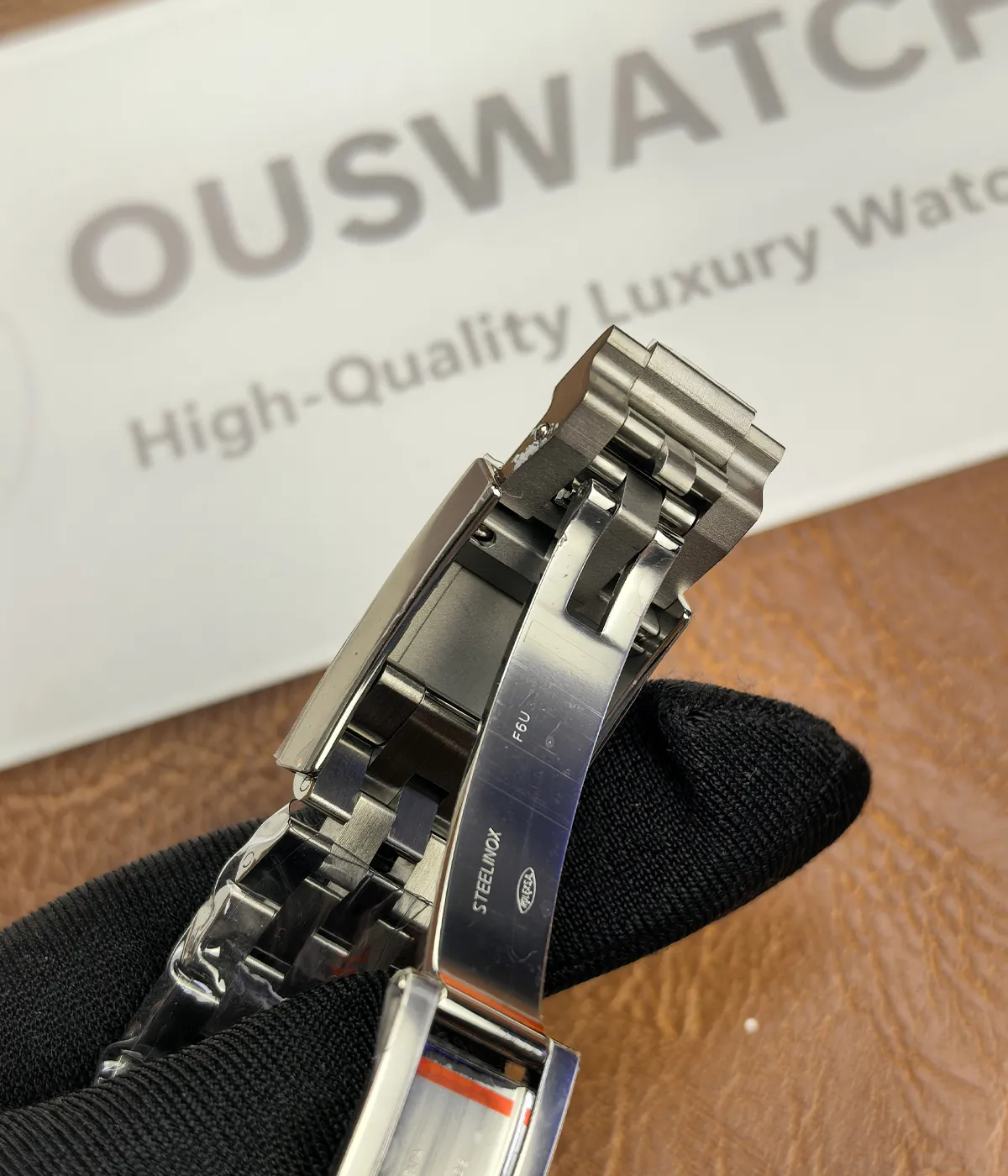 Detailed close-up of the clasp on the Rolex GMT-Master Blue M126710BLNR-0002 with a black dial and Oystersteel case.