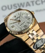 Close-up of the bezel and lugs on the Rolex Land-Dweller 127335-0001 with a rose gold case and white honeycomb textured dial.