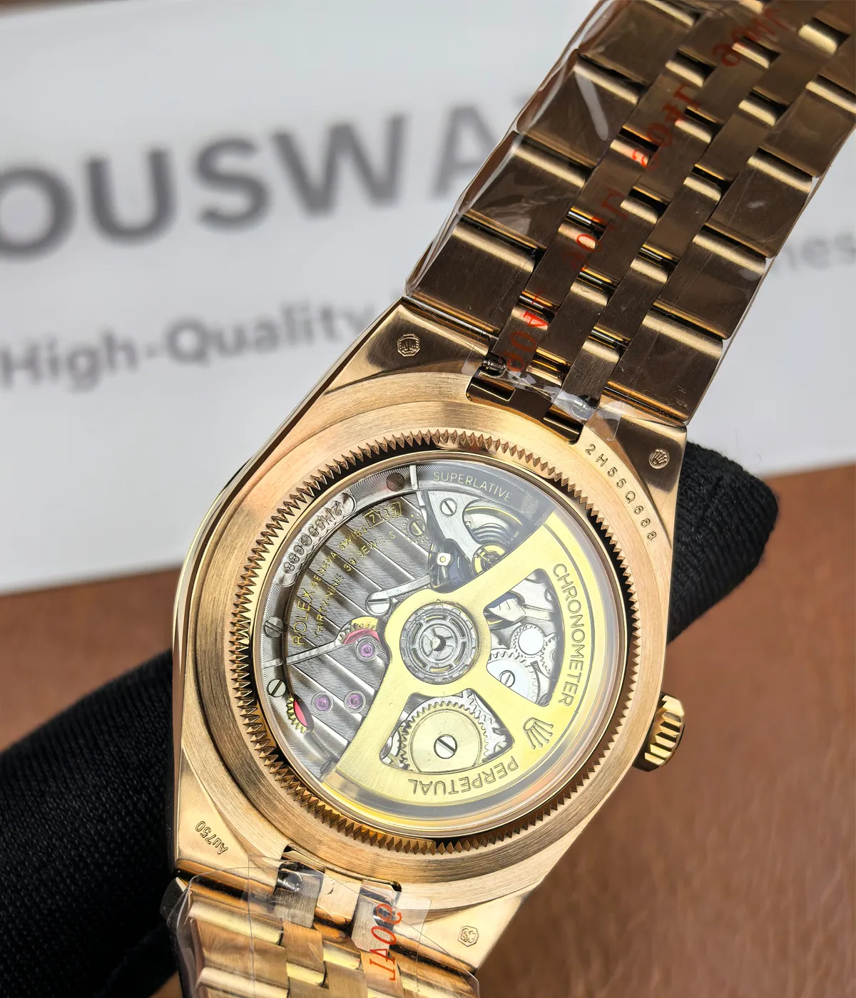 View of the transparent caseback on the Rolex Land-Dweller 127335-0001 with a rose gold case and white honeycomb textured dial.