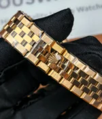 Close-up of the bracelet and clasp on the Rolex Land-Dweller 127335-0001 with a rose gold case.