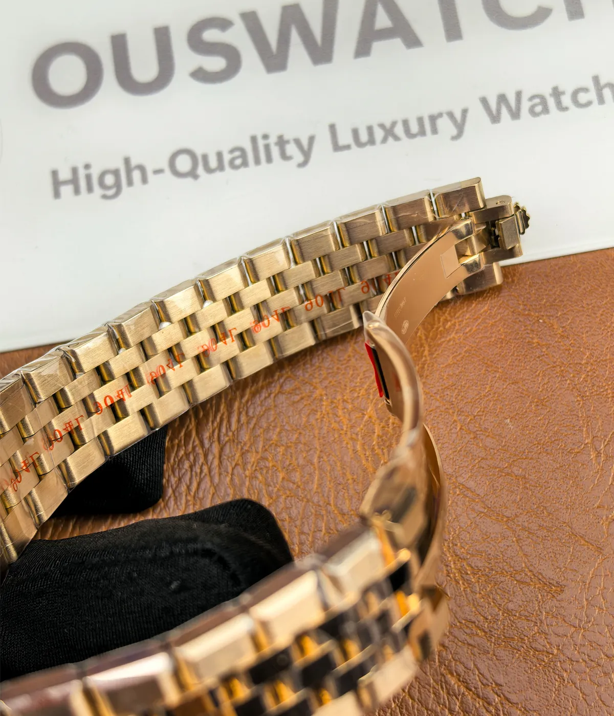 Close-up view of the clasp on the Rolex Land-Dweller 127335-0001 with a rose gold case.