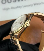 Close-up of the crown on the Rolex Land-Dweller 127335-0001 with a rose gold case.