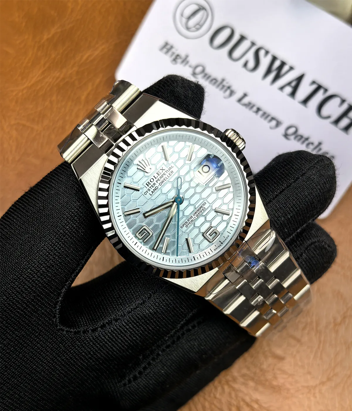 -45-degree angle view of the Rolex Land-Dweller 127336-0001 with a platinum case, triangular grooved bezel, and ice blue honeycomb textured dial.