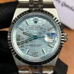 Front view of the Rolex Land-Dweller 127336-0001 with a platinum case, triangular grooved bezel, and ice blue honeycomb textured dial.