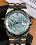 Front view of the Rolex Land-Dweller 127336-0001 with a platinum case, triangular grooved bezel, and ice blue honeycomb textured dial.
